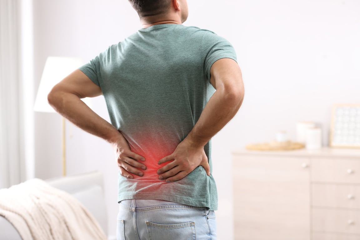 Man Suffering from Back Pain at Home. Bad Posture Problem